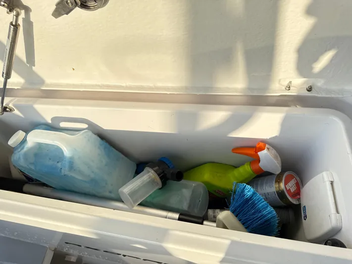  Yacht Photos Pics Storage compartment on a 2019 Axopar 28 CABIN with cleaning supplies and tools.