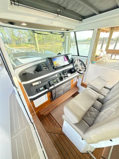  Yacht Photos Pics 2019 Axopar 28 CABIN interior with modern helm, leather seats, and navigation system.