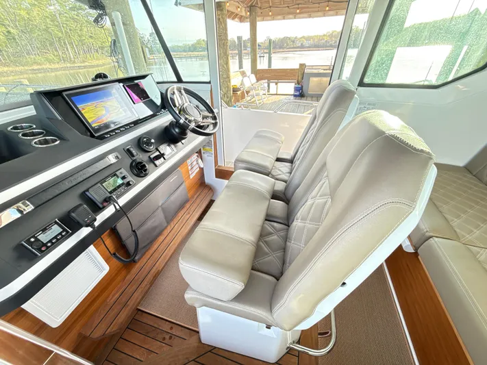  Yacht Photos Pics 2019 Axopar 28 CABIN interior with modern dashboard and comfortable seating.