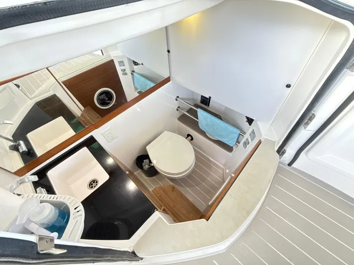  Yacht Photos Pics Interior of 2019 Axopar 28 CABIN boat bathroom with sink and toilet.