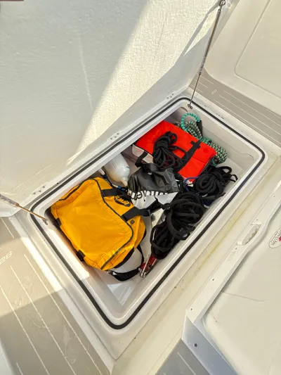  Yacht Photos Pics Storage compartment on 2019 Axopar 28 CABIN boat with safety gear and ropes.