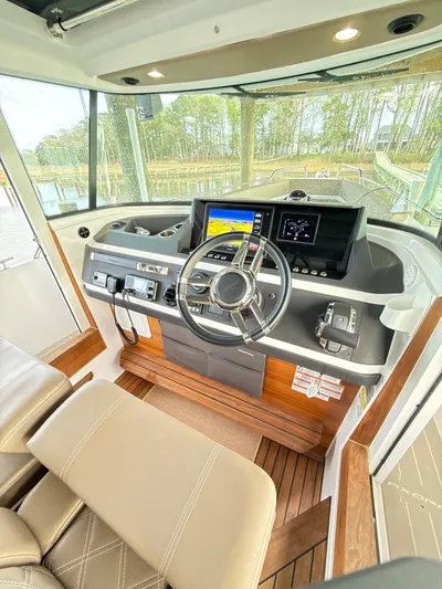  Yacht Photos Pics 2019 Axopar 28 CABIN helm with modern controls and navigation screens.