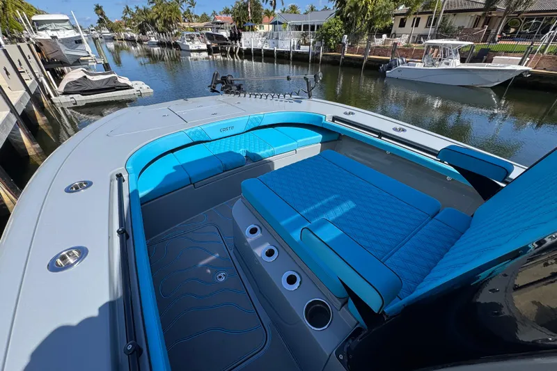  Yacht Photos Pics 2026 Costa Custom Boats 264 HC with blue seating, docked in a scenic marina.