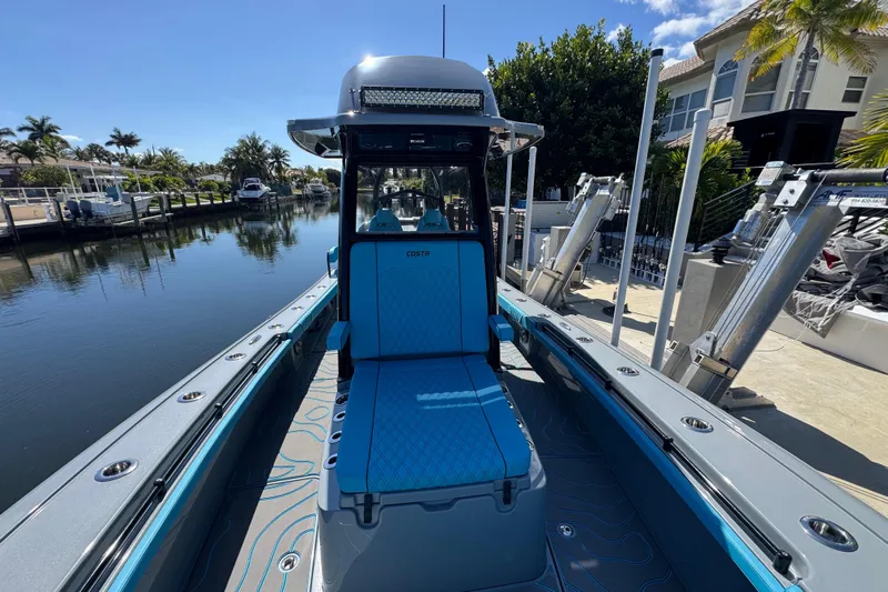  Yacht Photos Pics 2026 Costa Custom Boats 264 HC on a serene canal, showcasing sleek design and modern features.