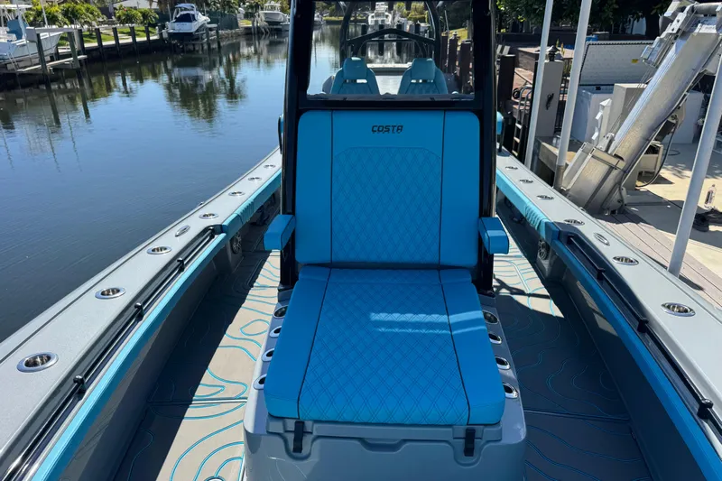  Yacht Photos Pics 2026 Costa Custom Boats 264 HC with blue seating, docked by a serene canal.