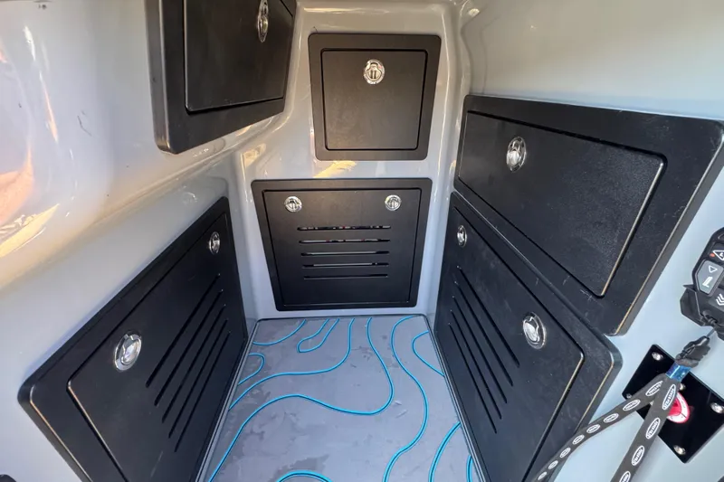  Yacht Photos Pics Storage compartments inside 2026 Costa Custom Boats 264 HC, featuring sleek black panels and modern design.