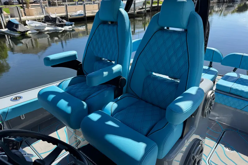  Yacht Photos Pics Luxurious blue seating on 2026 Costa Custom Boats 264 HC, docked by the water.