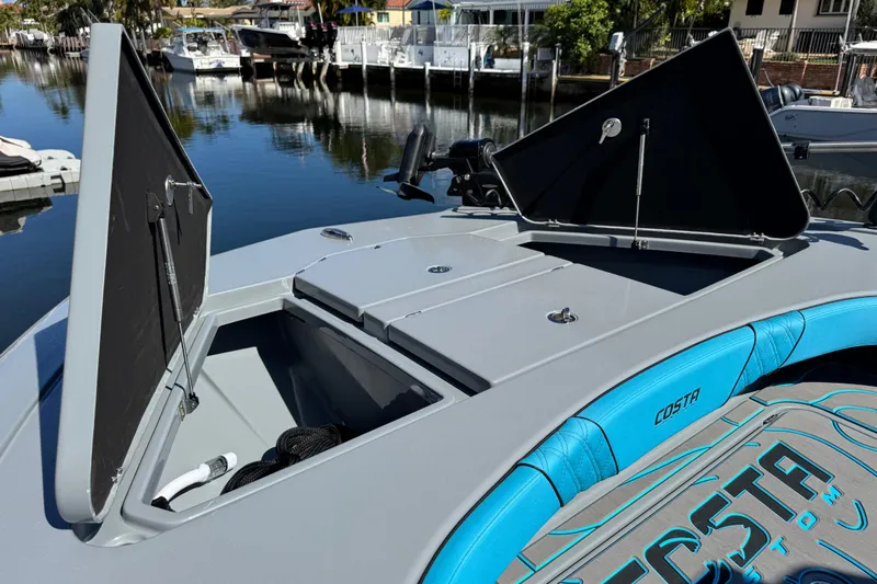  Yacht Photos Pics 2026 Costa Custom Boats 264 HC with open storage compartments, docked by a serene waterfront.