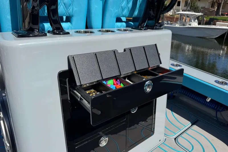  Yacht Photos Pics 2026 Costa Custom Boats 264 HC with open tackle storage, featuring blue seating and cup holders.