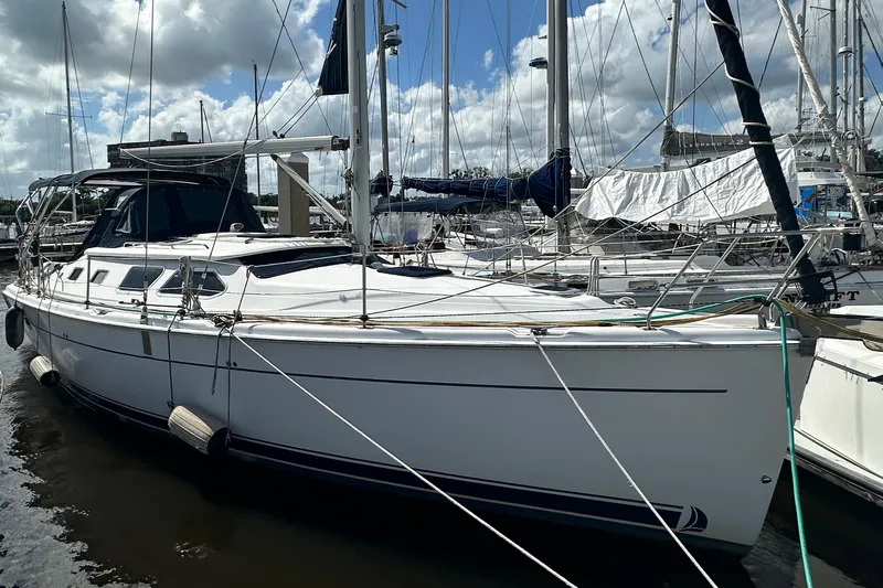 Ms Bea Haven Yacht Photos Pics 2006 Hunter 41 Deck Salon sailboat docked at marina under cloudy sky.