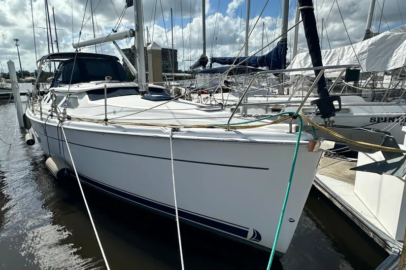 Ms Bea Haven Yacht Photos Pics 2006 Hunter 41 Deck Salon sailboat docked at marina under cloudy sky.