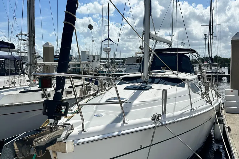 Ms Bea Haven Yacht Photos Pics 2006 Hunter 41 Deck Salon sailboat docked at marina under cloudy sky.