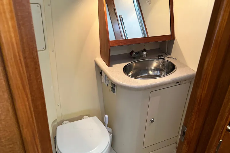 Ms Bea Haven Yacht Photos Pics 2006 Hunter 41 Deck Salon bathroom with sink, mirror, and toilet.