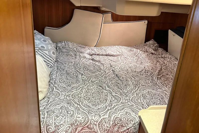 Ms Bea Haven Yacht Photos Pics Cozy cabin interior of 2006 Hunter 41 Deck Salon with patterned bedding.