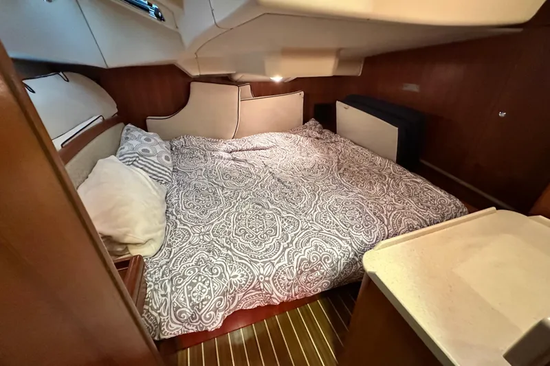 Ms Bea Haven Yacht Photos Pics Cozy cabin interior of 2006 Hunter 41 Deck Salon with patterned bedding.