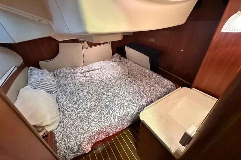 Ms Bea Haven Yacht Photos Pics Cozy cabin interior of 2006 Hunter 41 Deck Salon with patterned bedding and wooden accents.