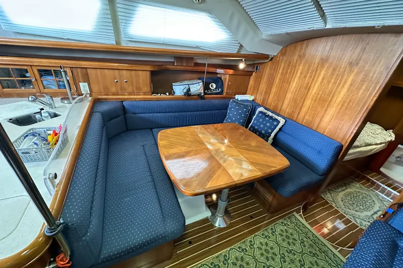 Ms Bea Haven Yacht Photos Pics Interior of 2006 Hunter 41 Deck Salon with cozy seating and wooden table.