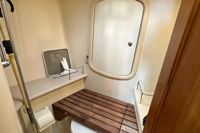 Ms Bea Haven Yacht Photos Pics Bathroom interior of 2006 Hunter 41 Deck Salon yacht with wooden bench and shower.