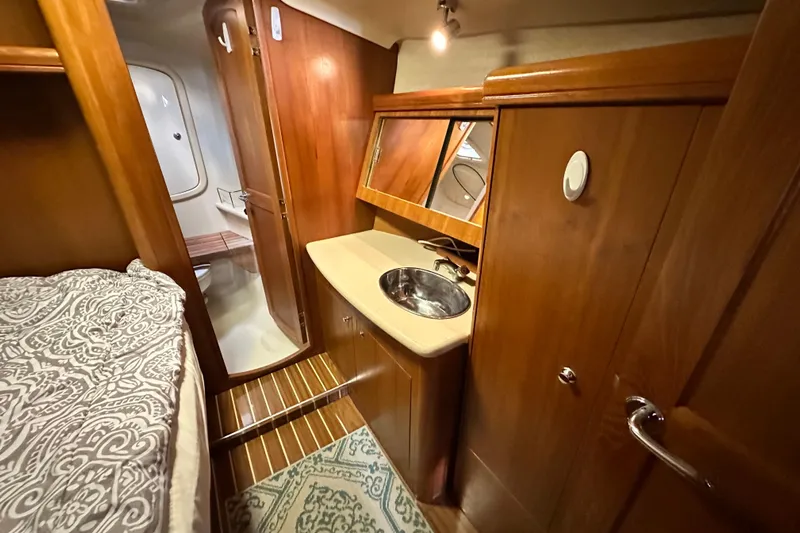 Ms Bea Haven Yacht Photos Pics Interior of 2006 Hunter 41 Deck Salon with wood finish and compact sink area.