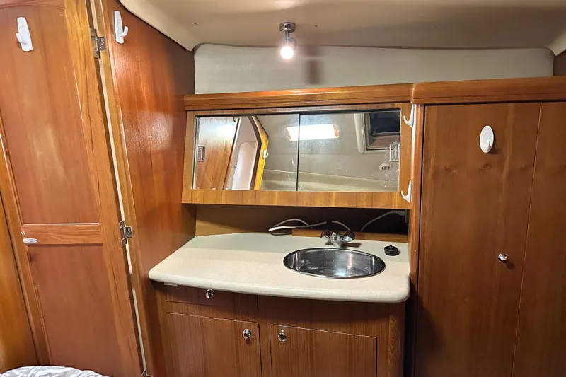 Ms Bea Haven Yacht Photos Pics Interior of 2006 Hunter 41 Deck Salon with wooden cabinetry and sink.