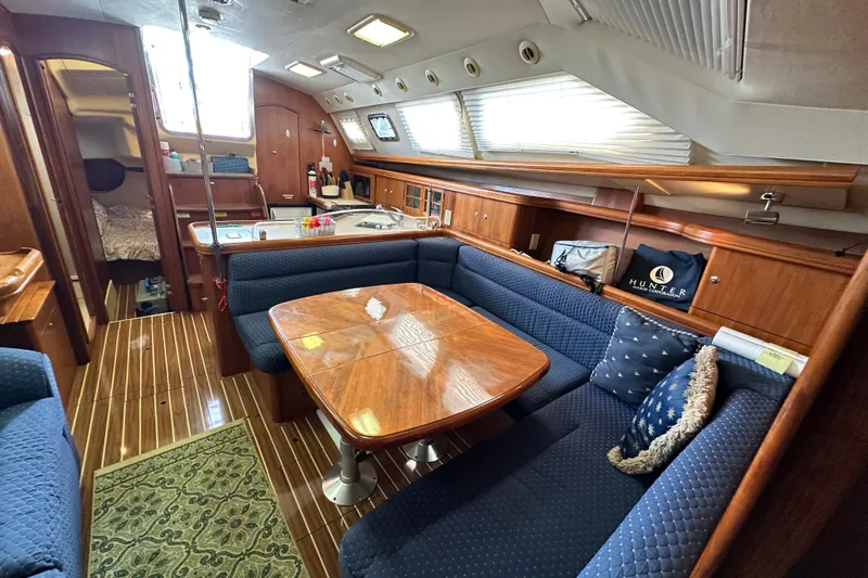 Ms Bea Haven Yacht Photos Pics Interior of 2006 Hunter 41 Deck Salon with elegant wood finish and cozy seating.