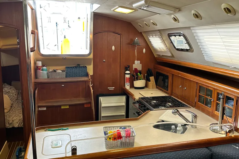 Ms Bea Haven Yacht Photos Pics Interior of 2006 Hunter 41 Deck Salon yacht, featuring a well-equipped kitchen area.