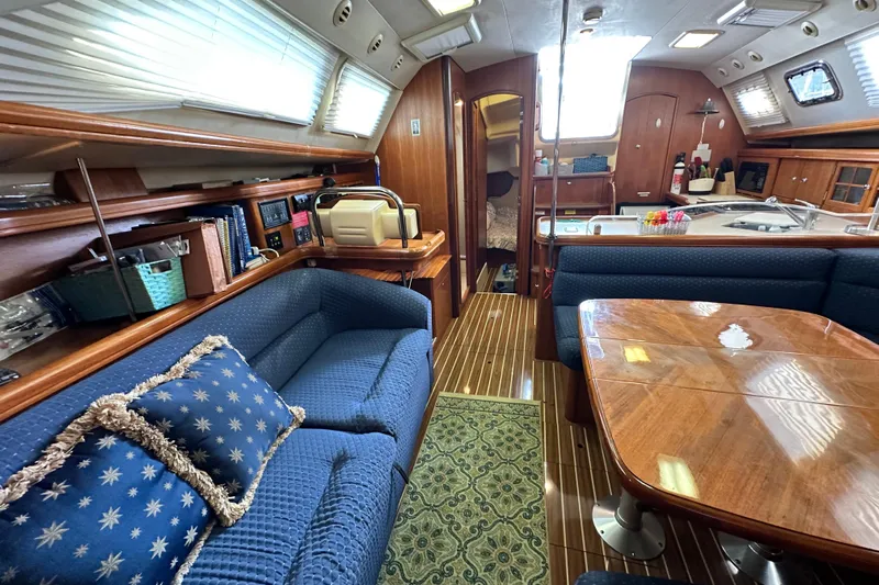Ms Bea Haven Yacht Photos Pics Interior of 2006 Hunter 41 Deck Salon yacht with cozy seating and wooden finishes.