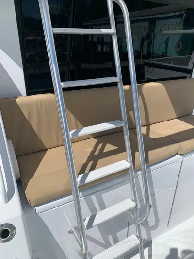 Pier Pressure Yacht Photos Pics Ladder on a 2000 Viking 50 Convertible yacht with beige seating.