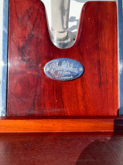 Pier Pressure Yacht Photos Pics Close-up of a Viking 50 Convertible 2000 boat's wooden detail with a metal plaque.