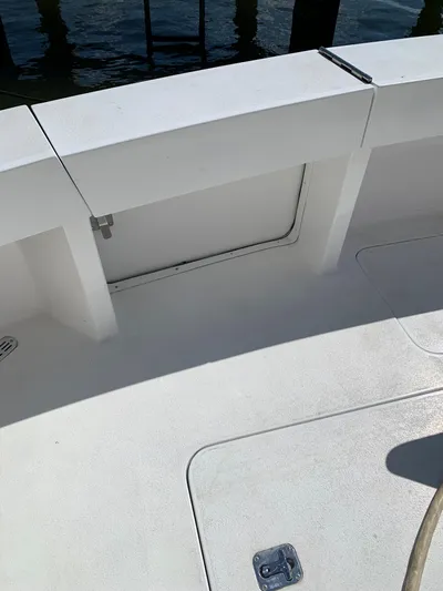 Pier Pressure Yacht Photos Pics 2000 Viking 50 Convertible boat deck with storage compartment, docked by the water.