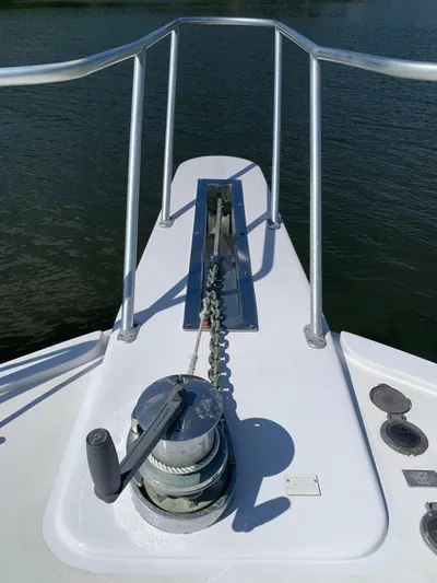 Pier Pressure Yacht Photos Pics Bow of 2000 Viking 50 Convertible yacht with anchor winch and railing.