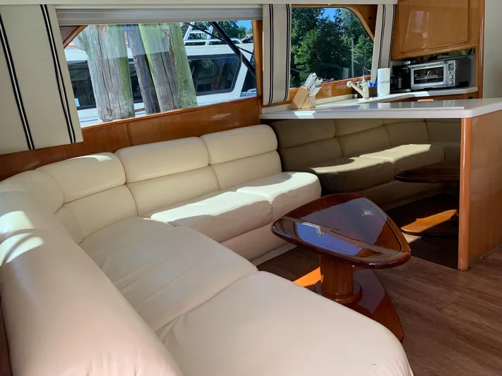 Pier Pressure Yacht Photos Pics Luxurious interior of a 2000 Viking 50 Convertible yacht with cream leather seating.