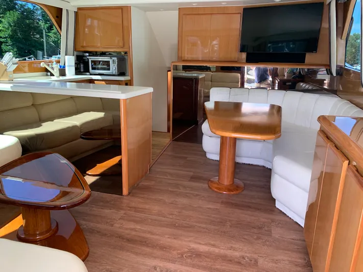 Pier Pressure Yacht Photos Pics Interior of a 2000 Viking 50 Convertible yacht with modern furnishings and wood accents.