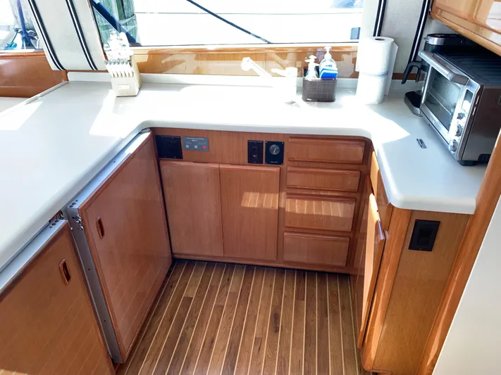 Pier Pressure Yacht Photos Pics 2000 Viking 50 Convertible yacht kitchen with wood cabinets and modern appliances.