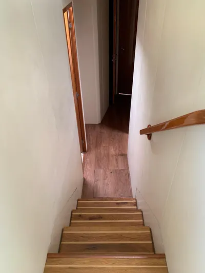 Pier Pressure Yacht Photos Pics Staircase inside 2000 Viking 50 Convertible yacht with wooden steps and handrail.