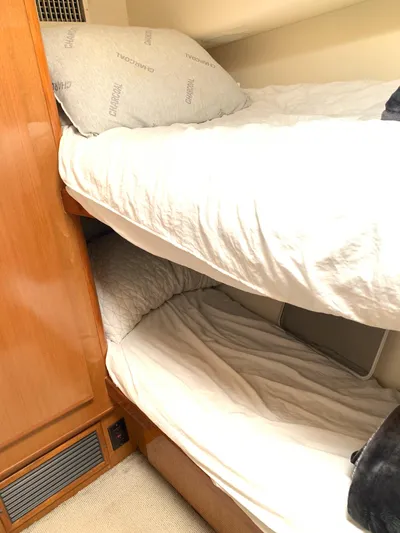 Pier Pressure Yacht Photos Pics Bunk beds in a 2000 Viking 50 Convertible yacht cabin with wooden paneling.