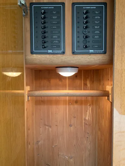 Pier Pressure Yacht Photos Pics Electrical panel inside a 2000 Viking 50 Convertible yacht, featuring wood cabinetry.
