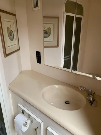 Pier Pressure Yacht Photos Pics Bathroom vanity in 2000 Viking 50 Convertible yacht with mirror and artwork.