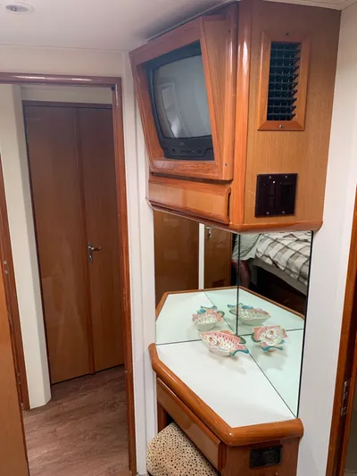 Pier Pressure Yacht Photos Pics Interior of a 2000 Viking 50 Convertible yacht with TV and decorative items.