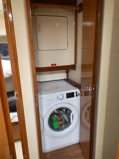 Pier Pressure Yacht Photos Pics Laundry area inside a 2000 Viking 50 Convertible yacht with washer and dryer.