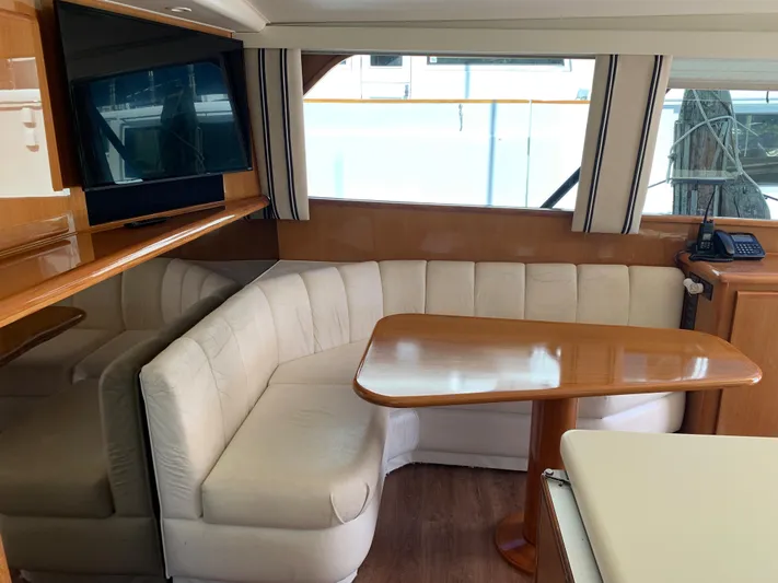 Pier Pressure Yacht Photos Pics Luxurious interior of a 2000 Viking 50 Convertible yacht with plush seating and wooden table.