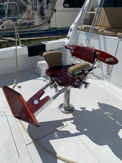 Pier Pressure Yacht Photos Pics Fishing chair on 2000 Viking 50 Convertible yacht deck, featuring polished wood and metal design.