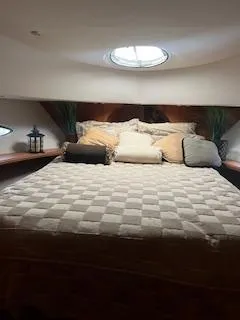 Yacht Photos Pics 2001 Silverton 410 Sport Bridge cabin with cozy bed and decorative pillows.