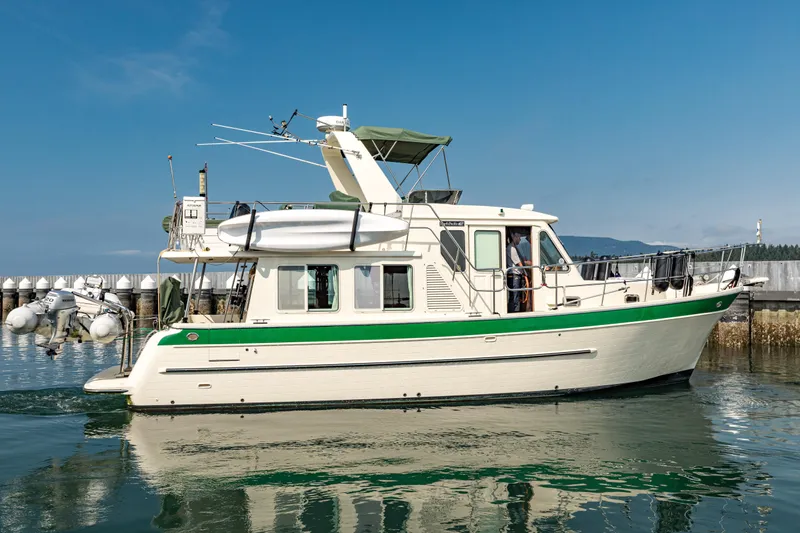 Greymalkin II Yacht Photos Pics 2008 North Pacific 39 Pilothouse boat docked in calm waters, clear sky background.