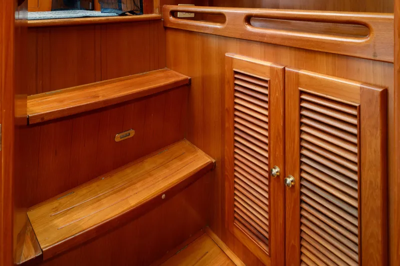 Greymalkin II Yacht Photos Pics Wooden interior stairs and cabinet on a 2008 North Pacific 39 Pilothouse boat.
