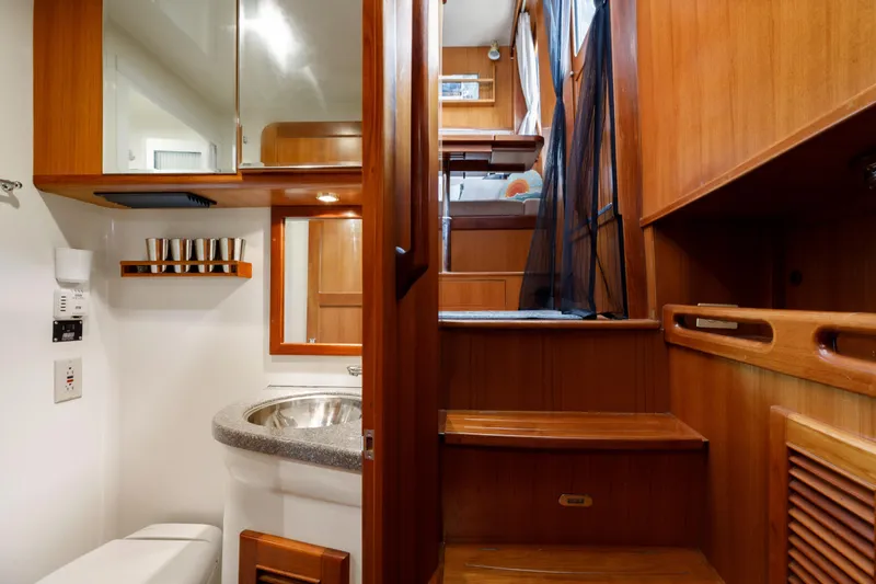 Greymalkin II Yacht Photos Pics 2008 North Pacific 39 Pilothouse interior with wooden stairs, bathroom, and cozy cabin.