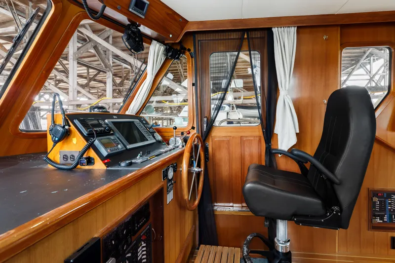 Greymalkin II Yacht Photos Pics Pilothouse interior of 2008 North Pacific 39, featuring navigation equipment and captain's chair.
