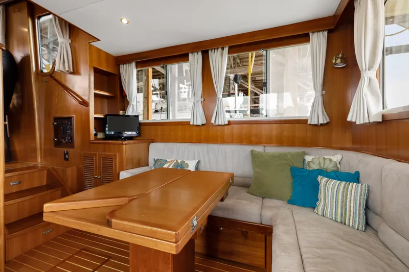 Greymalkin II Yacht Photos Pics Interior of 2008 North Pacific 39 Pilothouse with cozy seating and wooden table.