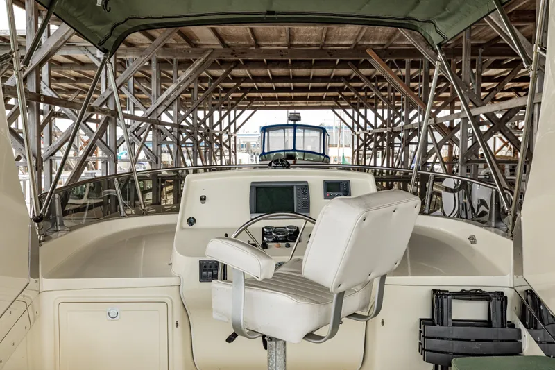 Greymalkin II Yacht Photos Pics 2008 North Pacific 39 Pilothouse helm with white captain's chair and navigation equipment.