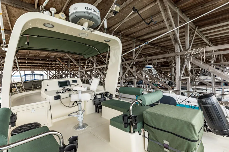 Greymalkin II Yacht Photos Pics 2008 North Pacific 39 Pilothouse boat interior with green seating and navigation equipment.